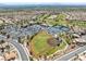 Aerial view of baseball field in a residential neighborhood with parking, golf course, and tennis courts at 10413 Marymont Pl, Las Vegas, NV 89134