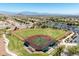 Aerial view of baseball field in a residential neighborhood with mountain views and parking at 10413 Marymont Pl, Las Vegas, NV 89134