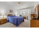 Bright bedroom with neutral walls, carpet, and large windows with shutter-style blinds at 10413 Marymont Pl, Las Vegas, NV 89134