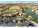 An exterior of the clubhouse, featuring manicured landscaping, parking, and lake views within the community at 10413 Marymont Pl, Las Vegas, NV 89134