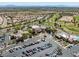 Aerial view of the community clubhouse, golf course, pool and a parking lot at 10413 Marymont Pl, Las Vegas, NV 89134
