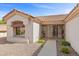 Inviting home entrance featuring a gated front porch and lush desert landscaping at 10413 Marymont Pl, Las Vegas, NV 89134