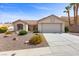 Charming home featuring a tile roof, a two car garage, and desert landscaping at 10413 Marymont Pl, Las Vegas, NV 89134