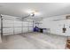 Clean, organized garage with a large roll-up door and plenty of room for parking and storage at 10413 Marymont Pl, Las Vegas, NV 89134