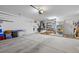 Spacious garage features concrete flooring, ample storage shelving, and access to essential utilities at 10413 Marymont Pl, Las Vegas, NV 89134