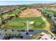 Aerial view of a golf course with sand traps and putting greens and a parking lot at 10413 Marymont Pl, Las Vegas, NV 89134