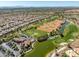 Aerial view of a golf course and pond in a residential neighborhood near the clubhouse at 10413 Marymont Pl, Las Vegas, NV 89134