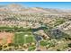 Aerial view of a golf course in a residential neighborhood near the clubhouse and pond at 10413 Marymont Pl, Las Vegas, NV 89134