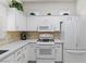 Well-lit kitchen showcasing white cabinetry, quartz countertops, and modern appliances at 10413 Marymont Pl, Las Vegas, NV 89134