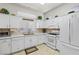 Bright kitchen featuring white cabinets, tile backsplash, and modern appliances at 10413 Marymont Pl, Las Vegas, NV 89134