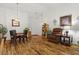 Inviting living room featuring hardwood flooring, a dining table, and comfortable seating at 10413 Marymont Pl, Las Vegas, NV 89134