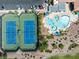 Overhead shot capturing tennis courts and the community pool, with vibrant landscaping and lounging areas for residents at 10413 Marymont Pl, Las Vegas, NV 89134