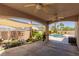 Covered patio overlooking a tranquil pond and private swimming pool in backyard at 1054 Broomfield Dr, Henderson, NV 89074