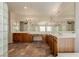 Large bathroom with double sinks, wood cabinets, tile floor and glass block shower at 1054 Broomfield Dr, Henderson, NV 89074