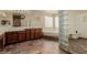 Spacious bathroom featuring a tiled floor, dark wood cabinets and shower with glass block at 1054 Broomfield Dr, Henderson, NV 89074