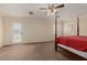 Large primary bedroom with a four poster bed, plantation shutters, and ceiling fan at 1054 Broomfield Dr, Henderson, NV 89074