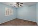 Empty bedroom with blue walls, carpet and a ceiling fan at 1054 Broomfield Dr, Henderson, NV 89074