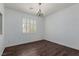 Bright bedroom with plantation shutters, neutral walls, and hardwood flooring at 1054 Broomfield Dr, Henderson, NV 89074