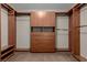 Walk-in closet with ample built-in wood shelving, drawers, and clothes rods at 1054 Broomfield Dr, Henderson, NV 89074