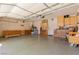 Spacious garage with a workbench and multiple storage cabinets at 1054 Broomfield Dr, Henderson, NV 89074