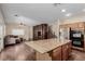 This expansive kitchen is adjacent to the living room with dark wood cabinets and a large kitchen island at 1054 Broomfield Dr, Henderson, NV 89074