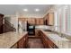 Gourmet kitchen with stainless steel appliances, granite countertops, and custom wood cabinetry at 1054 Broomfield Dr, Henderson, NV 89074