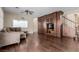 An open living room shows hardwood floors and a built-in entertainment center near the staircase at 1054 Broomfield Dr, Henderson, NV 89074