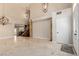Living room with high ceilings, chandelier, marble floors, columns, and a stairway to the upper level at 1054 Broomfield Dr, Henderson, NV 89074