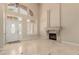 Living room with high ceilings, fireplace, neutral paint, tile floors, and a front door with sidelights at 1054 Broomfield Dr, Henderson, NV 89074