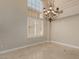 Living room featuring tile floors, chandelier, neutral paint, and shuttered windows to let in sunlight at 1054 Broomfield Dr, Henderson, NV 89074