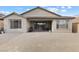 Expansive backyard featuring a covered patio and low-maintenance gravel landscaping with block wall at 10863 Gardenova Ave, Las Vegas, NV 89166
