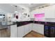 Stylish home bar with neon lighting, custom cabinetry, and a built-in beverage cooler at 10863 Gardenova Ave, Las Vegas, NV 89166