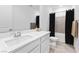 Clean bathroom featuring a modern sink, a shower with curtain and neutral wall, and a tiled floor at 10863 Gardenova Ave, Las Vegas, NV 89166