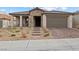 Beautiful single-story home featuring a stone facade, manicured landscaping, and a two-car garage at 10863 Gardenova Ave, Las Vegas, NV 89166