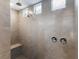 Spacious tiled shower stall with dual shower heads and a built-in seat for added comfort at 10863 Gardenova Ave, Las Vegas, NV 89166