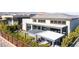 Beautiful backyard featuring a covered patio, outdoor seating, and lush landscaping at 11015 Sanctuary Cove Ct, Las Vegas, NV 89135