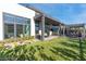 Backyard featuring lush lawn, covered patio, outdoor seating, and modern landscaping at 11015 Sanctuary Cove Ct, Las Vegas, NV 89135