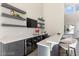 Stylish bar area with beverage coolers, floating shelves, modern finishes, and seating for entertaining at 11015 Sanctuary Cove Ct, Las Vegas, NV 89135