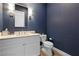 Powder room with blue accent wall, floating vanity and wood look floors at 11015 Sanctuary Cove Ct, Las Vegas, NV 89135