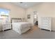 Cozy bedroom showcasing neutral tones, carpet, and a decorative white dresser at 11015 Sanctuary Cove Ct, Las Vegas, NV 89135