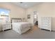 Cozy bedroom with neutral tones, a window view, and an ensuite bathroom at 11015 Sanctuary Cove Ct, Las Vegas, NV 89135