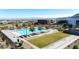 Aerial view of the community pool, with ample seating, landscaping, and mountain views in the background at 11015 Sanctuary Cove Ct, Las Vegas, NV 89135