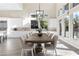 Dining area with a large wooden table, modern light fixture and lots of light at 11015 Sanctuary Cove Ct, Las Vegas, NV 89135