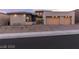 Contemporary home featuring a three-car garage and desert landscaping in the front yard at 11015 Sanctuary Cove Ct, Las Vegas, NV 89135