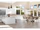 Open kitchen and dining area featuring stainless steel appliances, island seating, and a large dining table at 11015 Sanctuary Cove Ct, Las Vegas, NV 89135