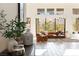 Bright living room with large windows, tile floors, and modern furniture at 11015 Sanctuary Cove Ct, Las Vegas, NV 89135