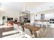Open-concept living space with large table, a modern kitchen, and a comfortable living room area at 11015 Sanctuary Cove Ct, Las Vegas, NV 89135