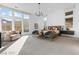Spacious main bedroom with a large window, seating area, and modern decor at 11015 Sanctuary Cove Ct, Las Vegas, NV 89135