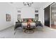 This main bedroom has a carpeted floor, modern chandelier and a sliding barn door at 11015 Sanctuary Cove Ct, Las Vegas, NV 89135