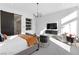 Spacious main bedroom with natural light, modern furnishings, and a barn door leading to the bathroom at 11015 Sanctuary Cove Ct, Las Vegas, NV 89135